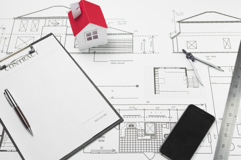 cellphone-clipboard-with-small-house-model-blueprint